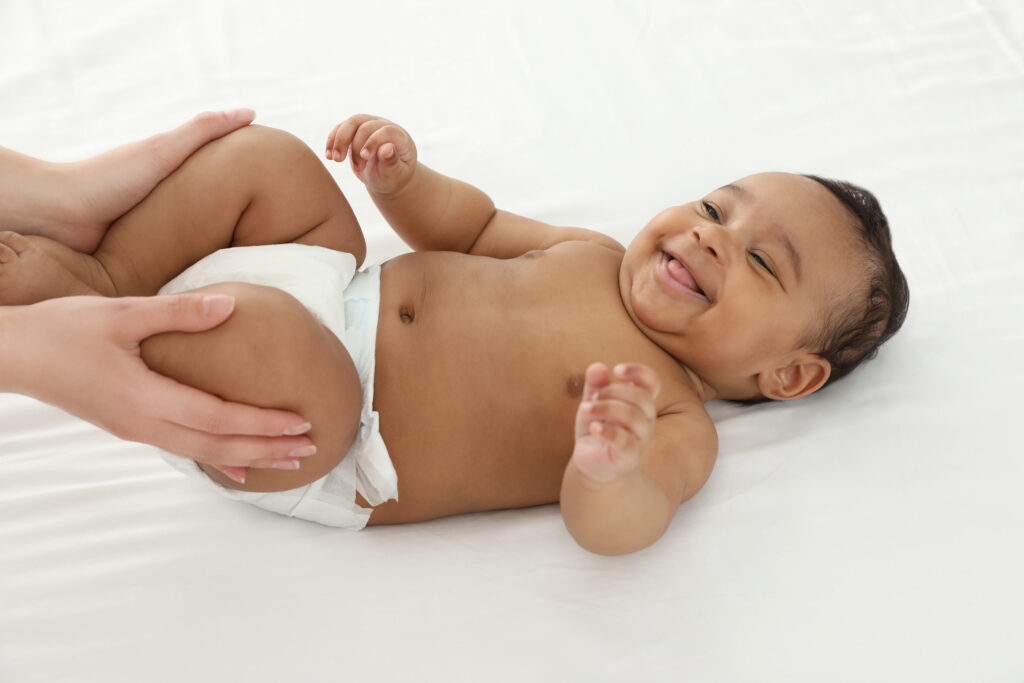 Parent massaging baby’s legs – exploring infant massage benefits