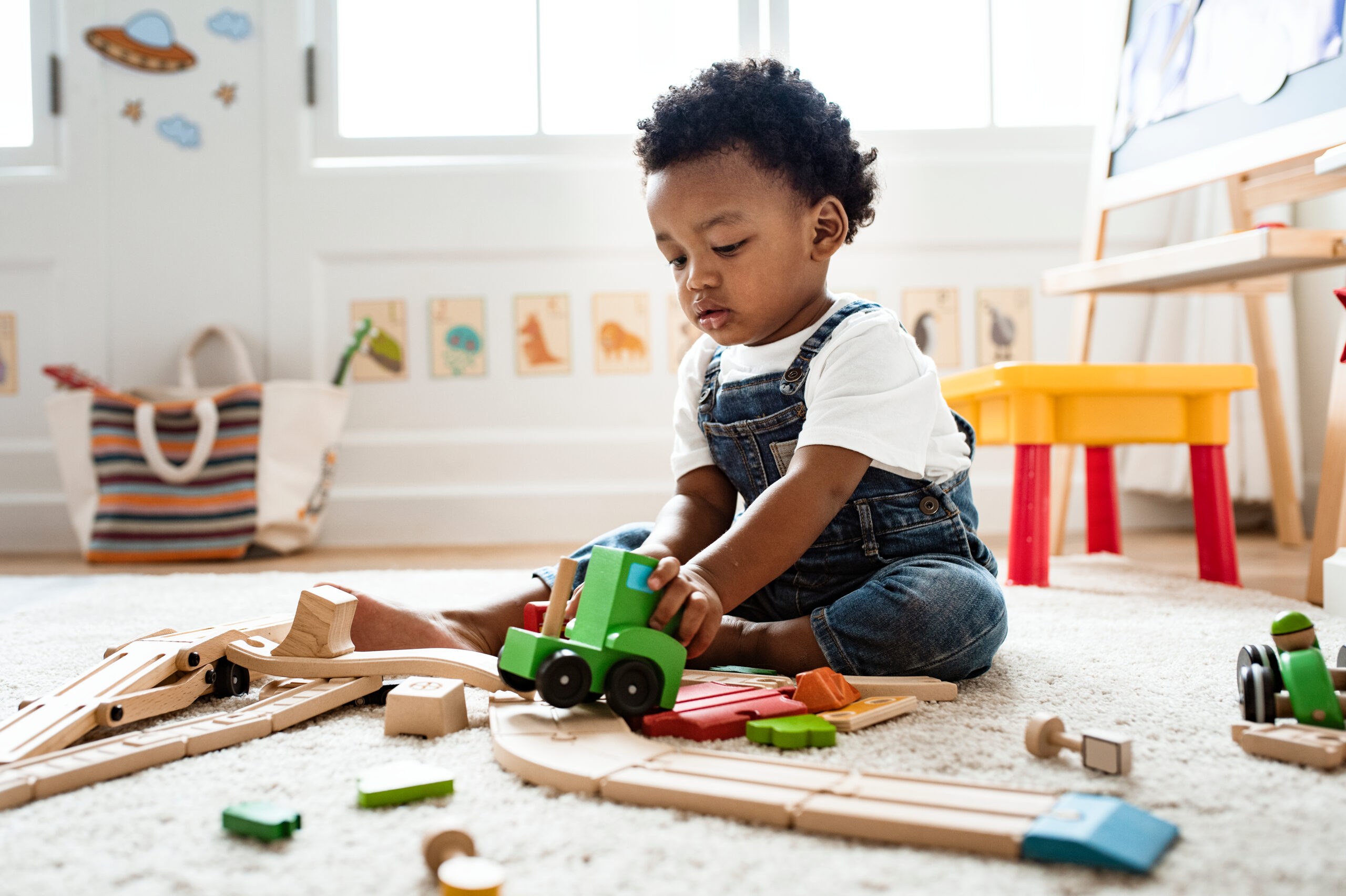 Cute,Little,Boy,Playing,With,A,Railroad,Train,Toy healthy baby playing – vitamin D supplementation for newborns
