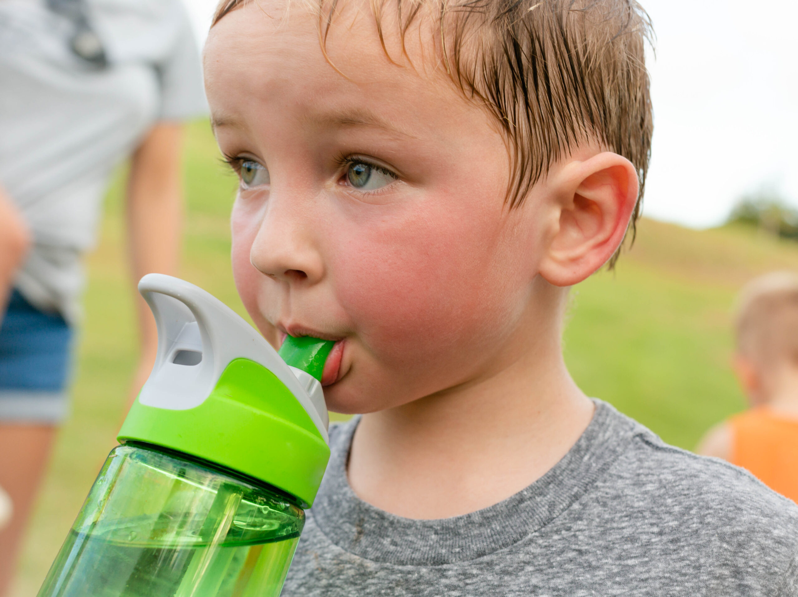 Children,Drinking,Water.,A,Thirsty,Boy,Taking,A,Water,Break Child playing outside in summer heat – heat exhaustion vs heat stroke in children