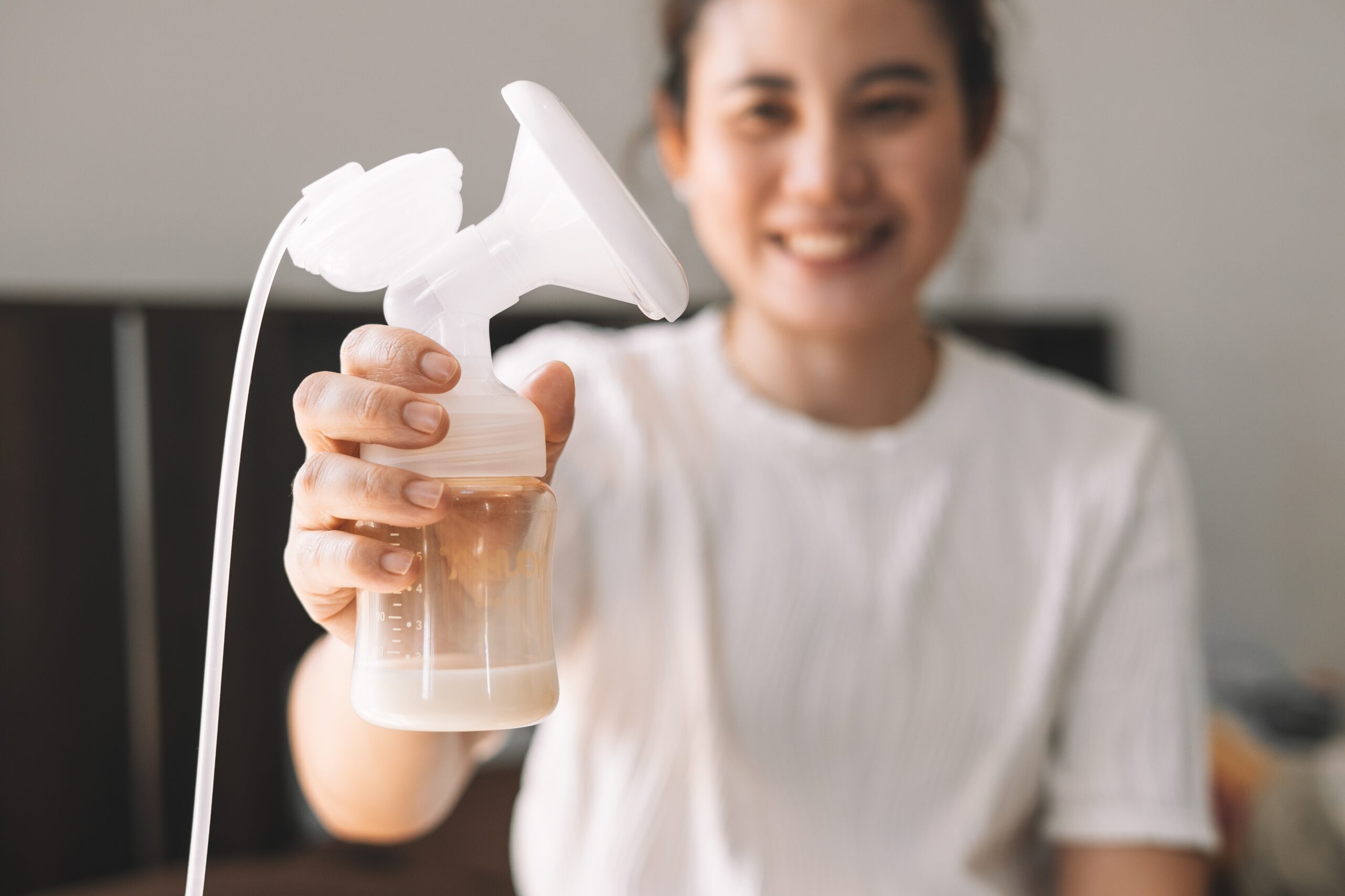Mom,Using,Breast,Pump,Machine,To,Pumping,Milk,For,Her mom using a breast pump at home – using a breast pump
