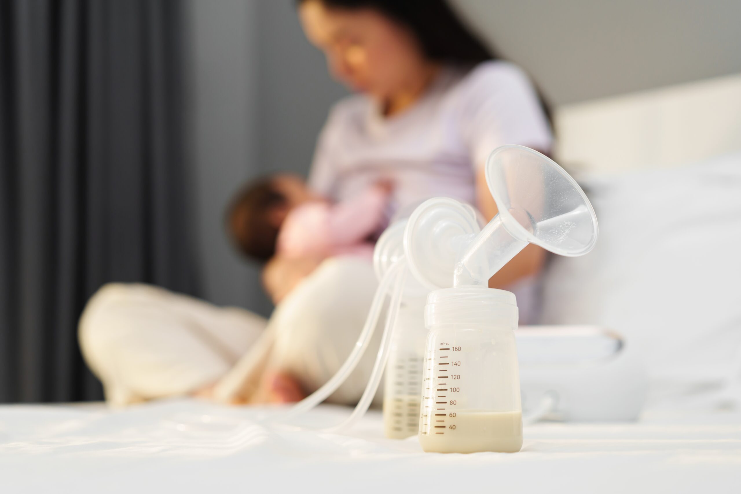 The,Breast,Milk,Are,In,The,Bottles,Of,Electric,Breast mom using a breast pump at home – using a breast pump