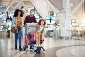 Family in airport with toddler – holiday travel with young children