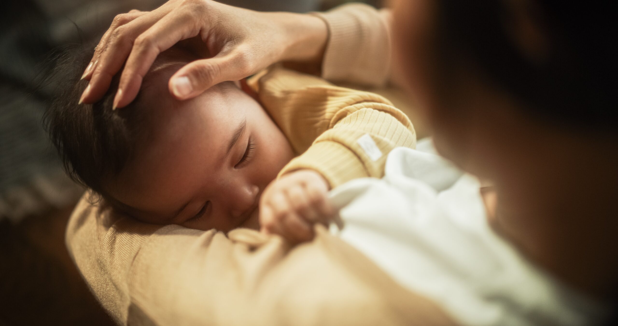 Close-up of baby with deep latch during breastfeeding - nipple care while breastfeeding
