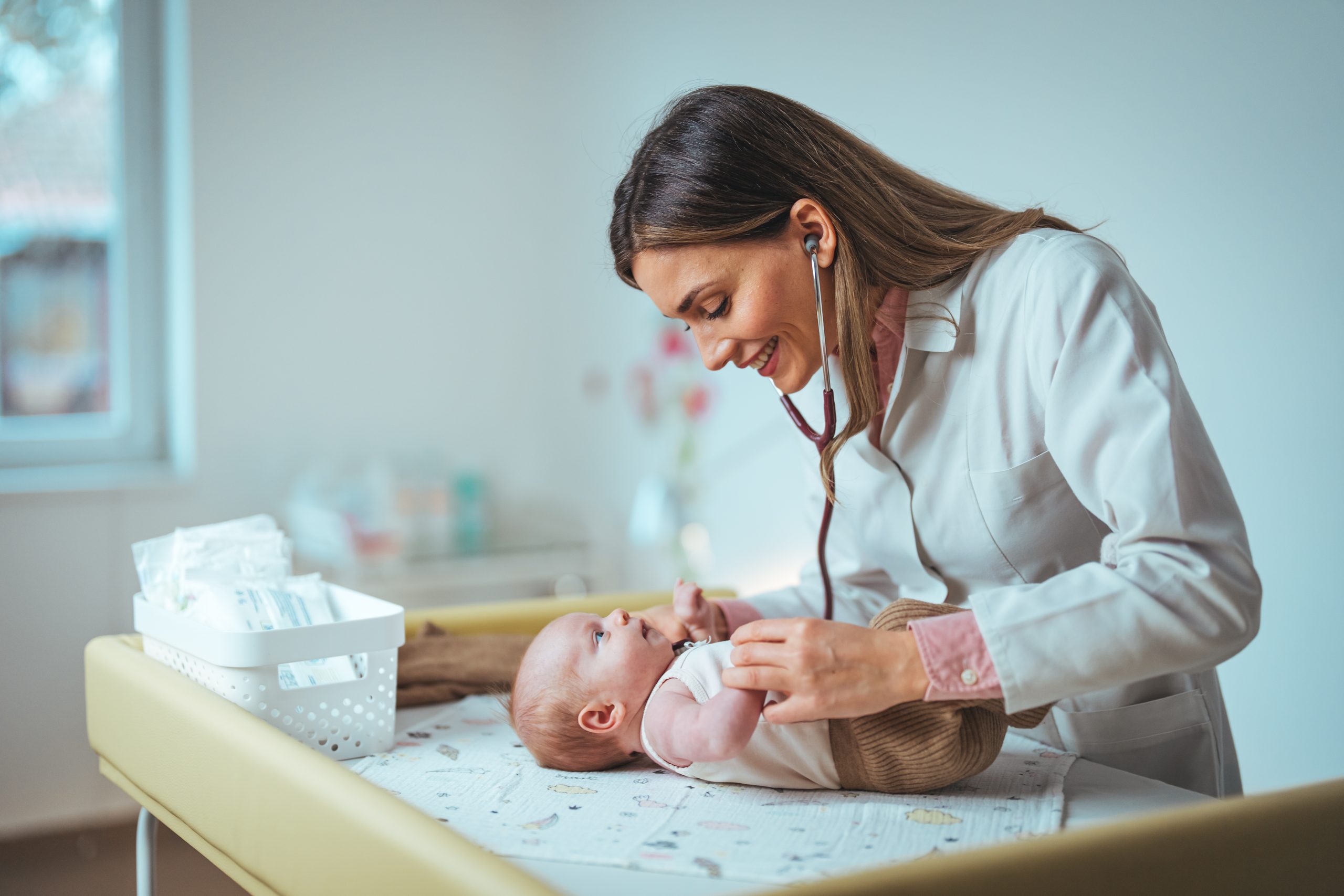 A,Smiling,Caucasian,Female,Pediatrician,Listens,To,A,Newborn's,Heartbeat